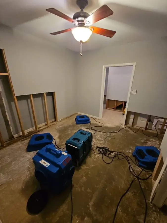 Air movers and dehumidifiers drying a Johnston County room